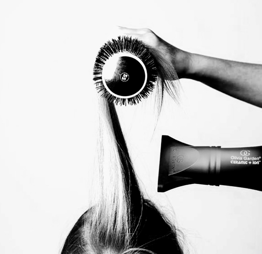 Hair stylist blow-drying hair